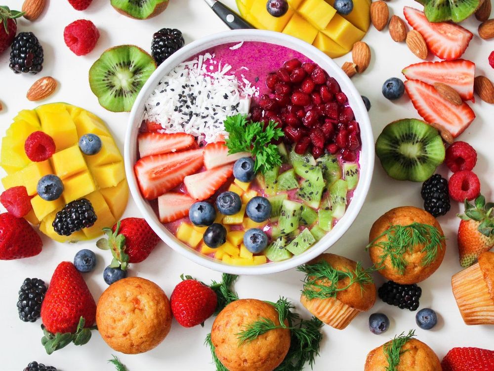 A smoothie bowl topped with strawberries, berries and fresh fruit